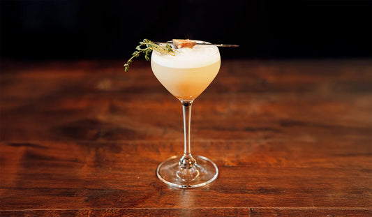 Fig & Thyme Whiskey Sour cocktail on a table