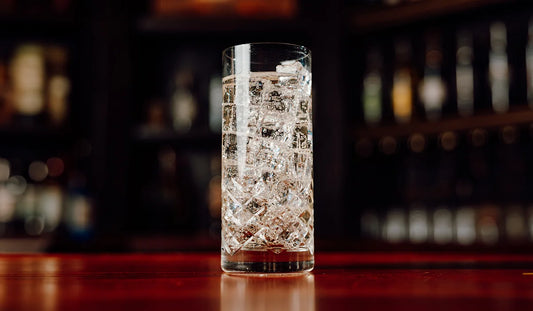 A glass of Takamine Whiskey Japanese Highball on a bar